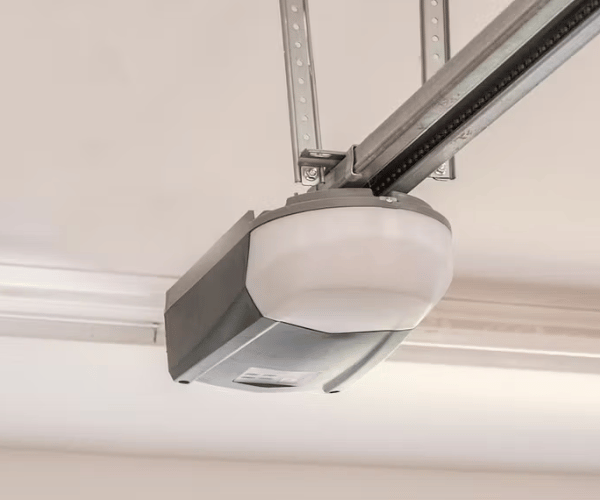 Professional technician repairing garage door opener motor unit in San Francisco Bay Area home