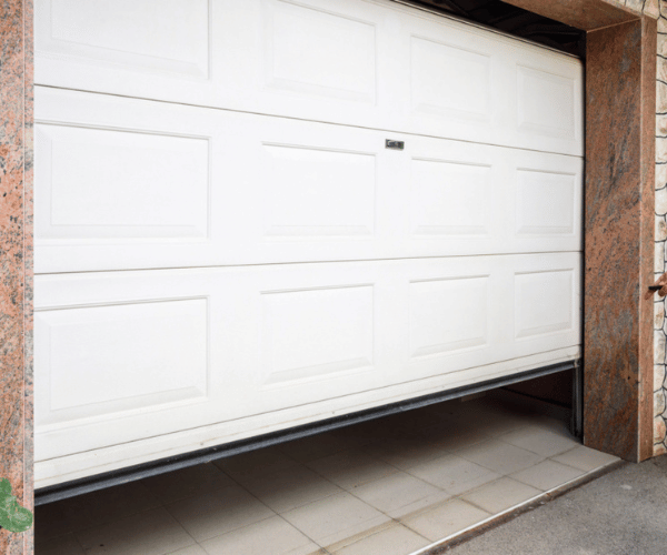 Technician testing garage door opener backup battery system in San Francisco Bay Area home