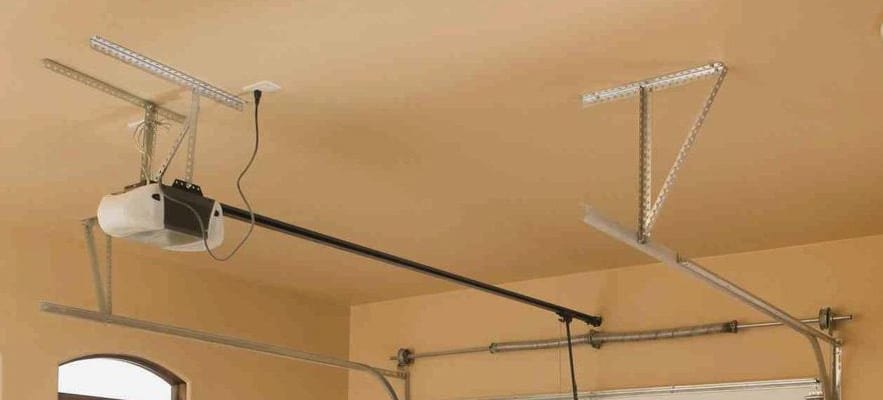 Genie garage door opener mounted on a residential garage ceiling